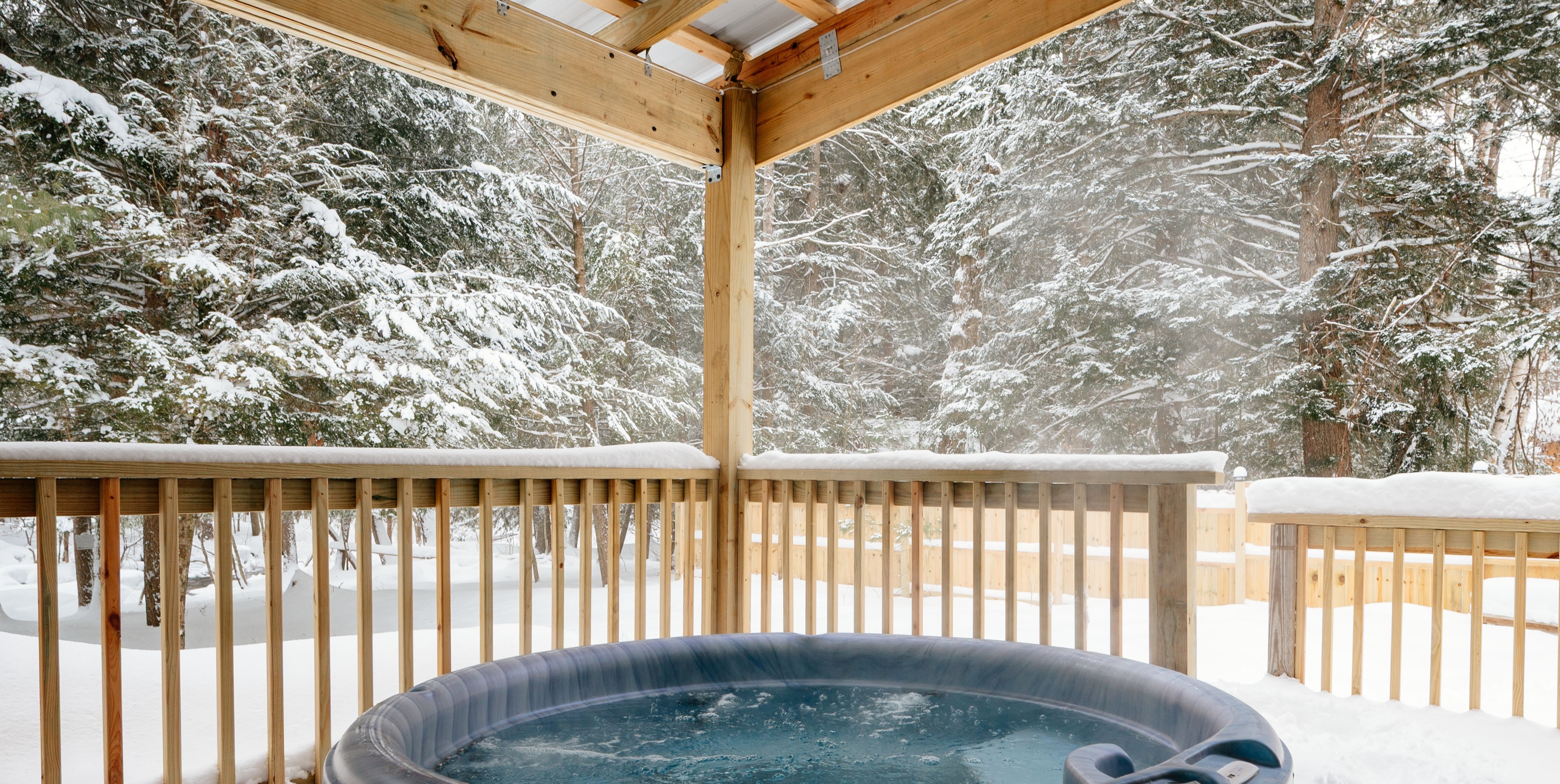 Streamside — covered hot tub in the snow